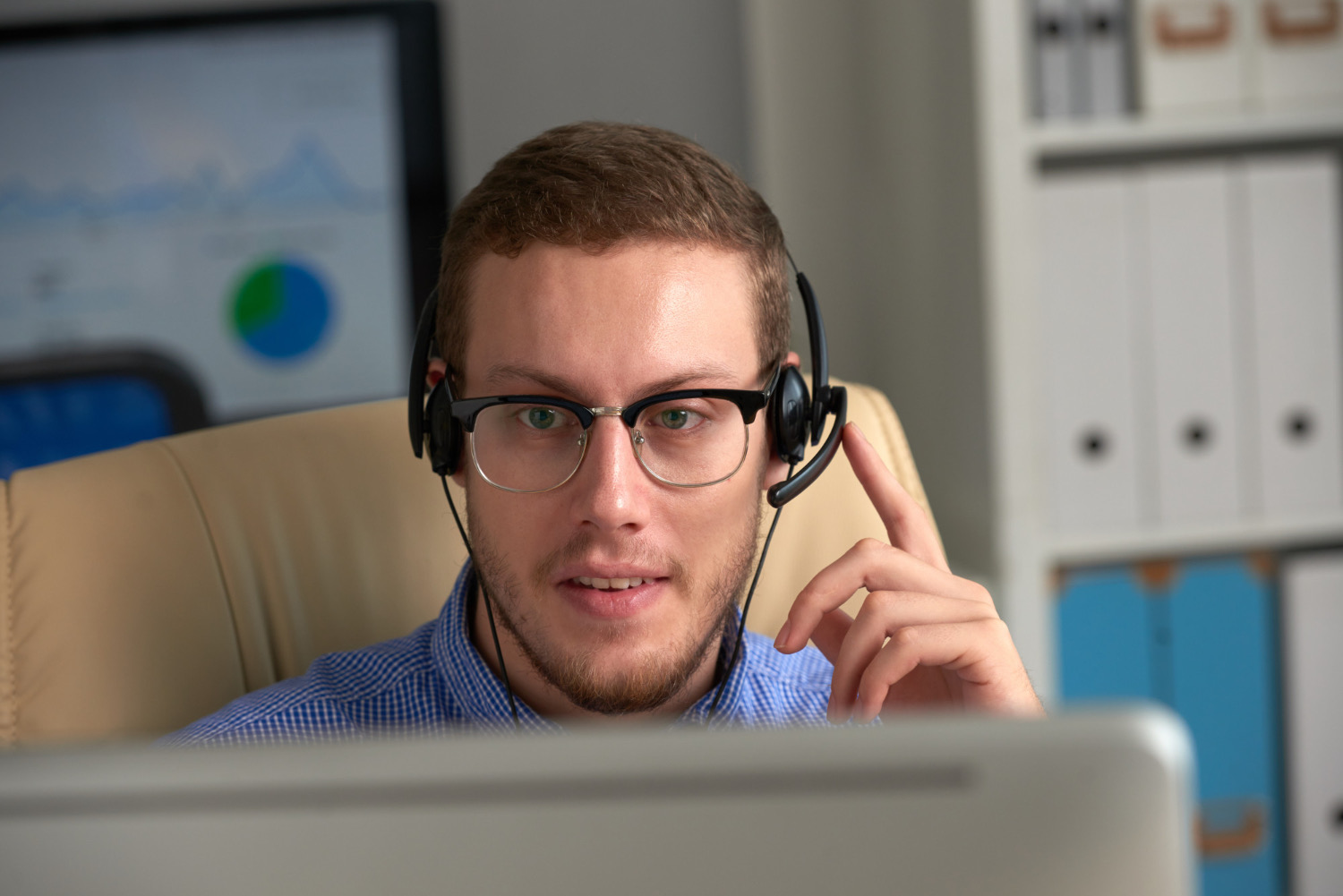 University Phone System | VitalPBX for Higher Ed 3 Admissions call agent wearing a headset at a computer