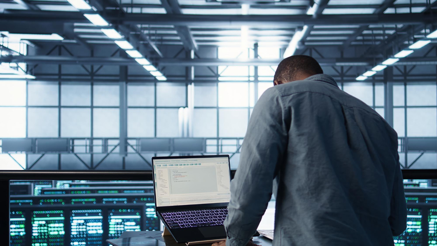 University Phone System | VitalPBX for Higher Ed 5 IT staff working in a data center server room