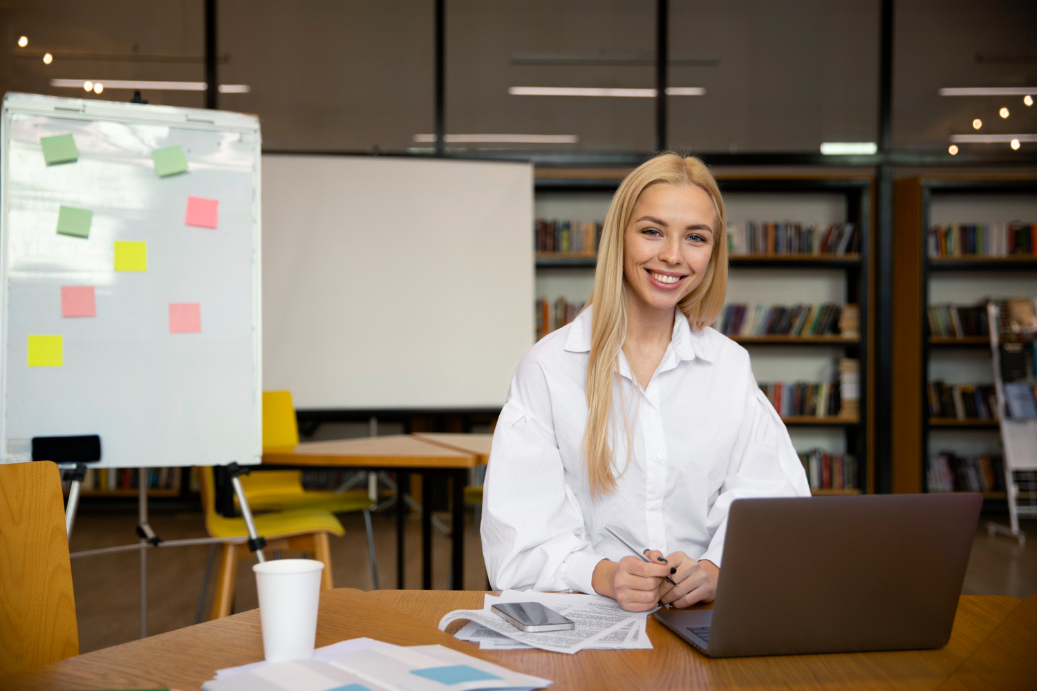 University Phone System | VitalPBX for Higher Ed 4 Staff member in a hybrid meeting on a laptop